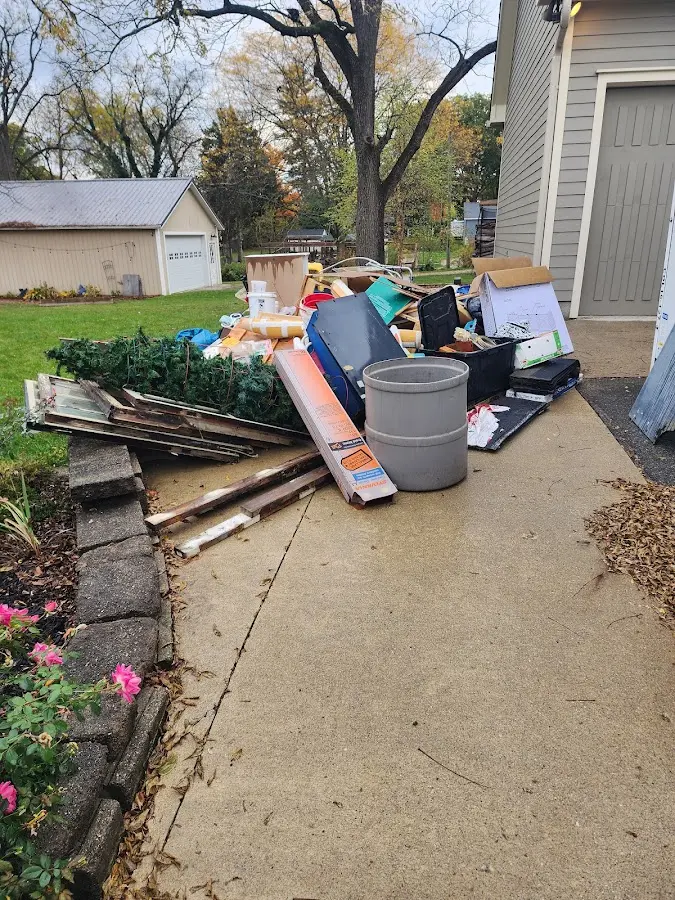 Dumpster being loaded with debris for Commercial Dumpster Rental in Troutdale